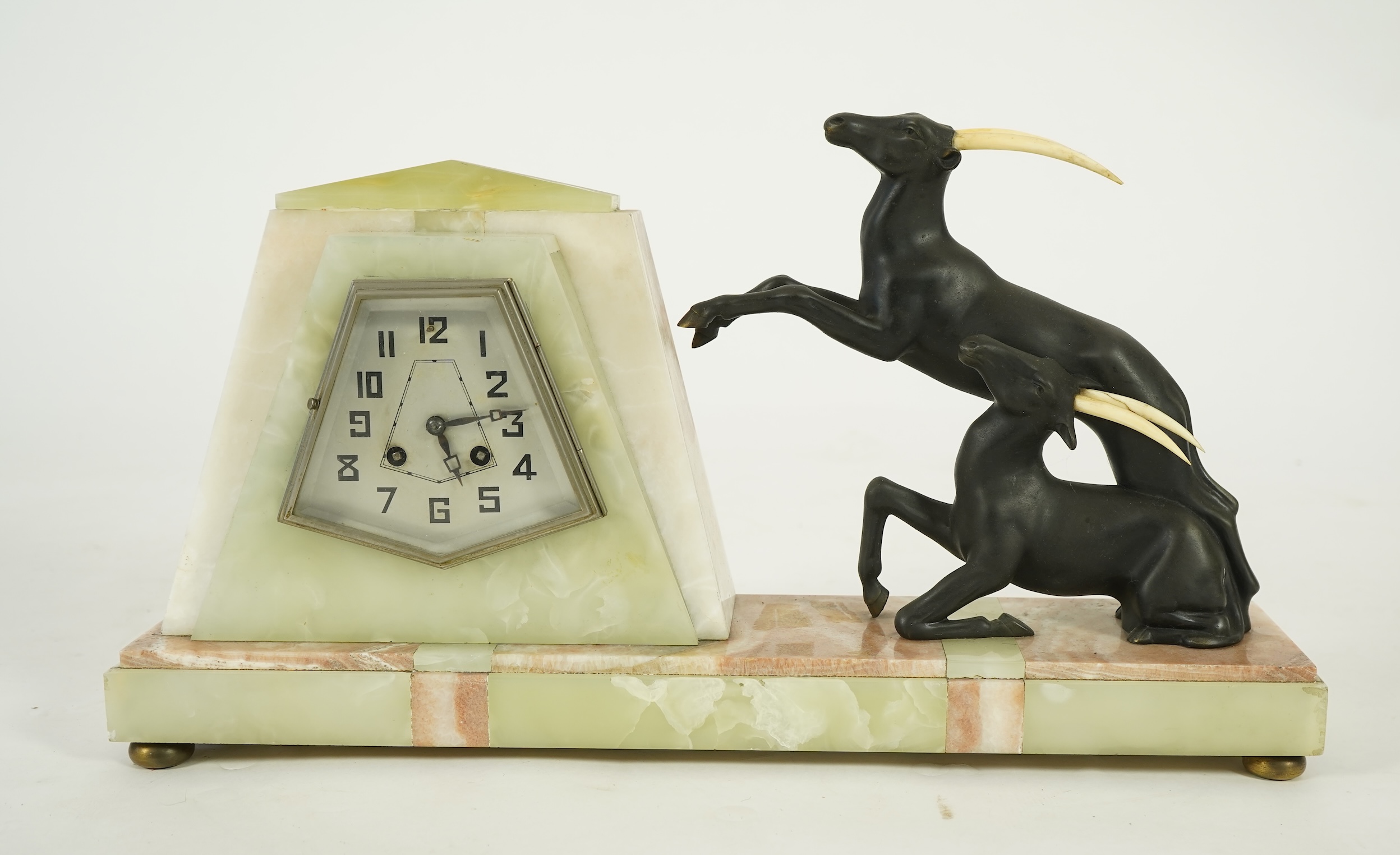 Attributed to Uriano (Ugo Cipriani, Italian, 1897-1960), a French green and cream onyx pyramid shaped clock